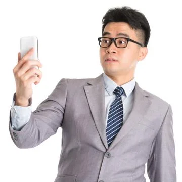 Get shocked while reading on smart phone. Stock Photos