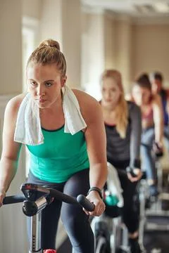 Fit Young Woman Sweating during a Gym Workout with Rings Stock