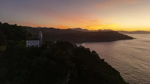 Getaria lighthouse at dawn overlooking Cantabrian Sea Stock Photos