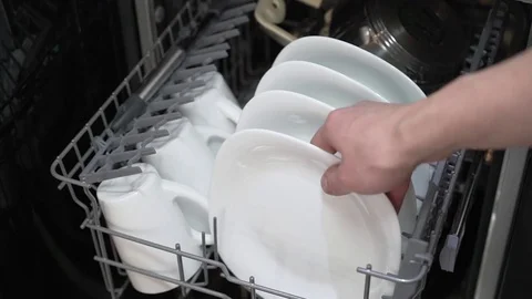 Gets a clean plate from the dishwasher 스톡 동영상 75685543