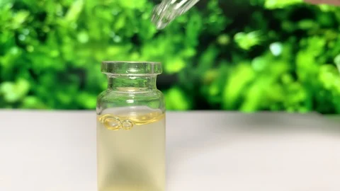 Gets oil from  bottle on  background of grass. CBD pipette.  Bottle of Cannabis  Stock-Footage 122699852