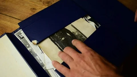 Gets out of the folder very old photograph of a man in military uniform Stock Footage 112918952