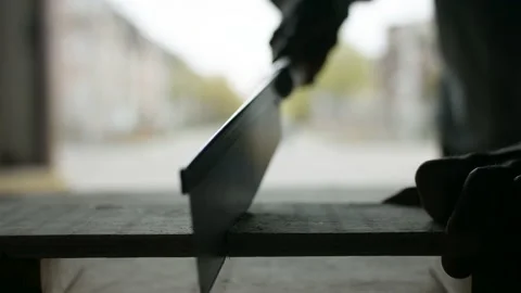 Getting back to work on construction site. Hand sawing wood. Stock Footage 130414579