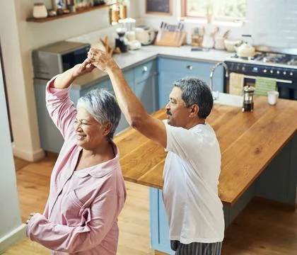 Getting in a bit of morning dancing. Shot of a cheerful elderly couple dancin Stock Photos