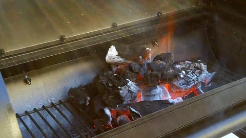 Getting the Charcol ready for the Summer BBQ. Meats will be cooking in No Stock Footage 108463825