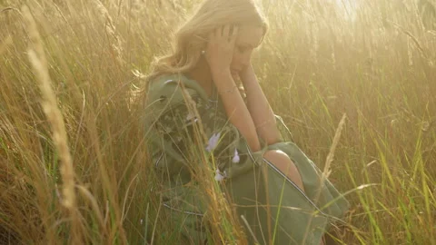 Getting close to a sad beautiful young woman in tears sitting in the deep field Stock Footage 229949074