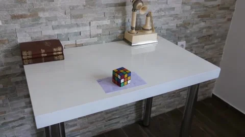 Getting closer to the puzzle cube on table Video stock 158869905