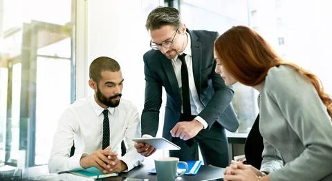 Getting constructive input from every team member. a team of executives having a Stock Photos