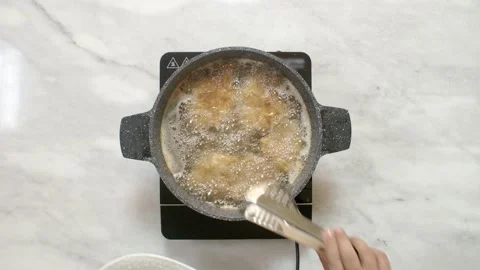 Getting cooked fish fillet out of the frying pan, top view Stock Footage 135181604