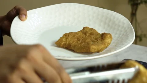Getting cooked fish fillet out of the frying pan Stock Footage 135184558