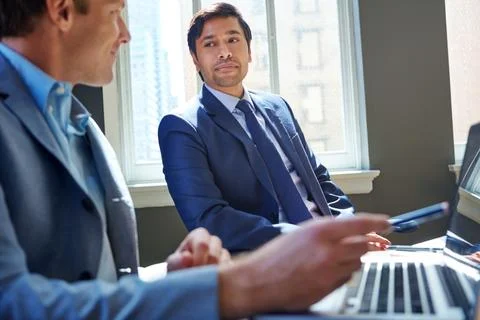 Getting down to the brass tacks of business. businessmen working in their office Stock Photos
