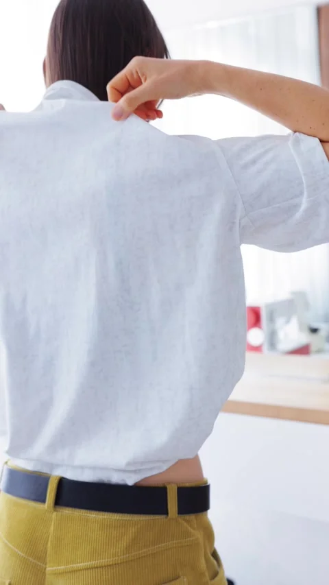 Getting Dressed: Putting on White T-Shirt Stock Footage 268792938