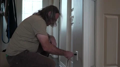 Getting an Electric Shock While Plugging a Cable Stock Footage 158061627