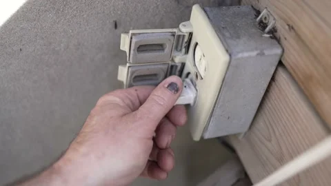 Getting Electrocuted by an Exterior Electrical Outlet Closeup Stockbeeldmateriaal 195590296