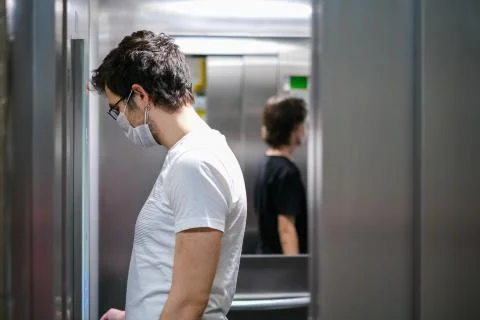 Getting on the elevator on corona days Stock Photos