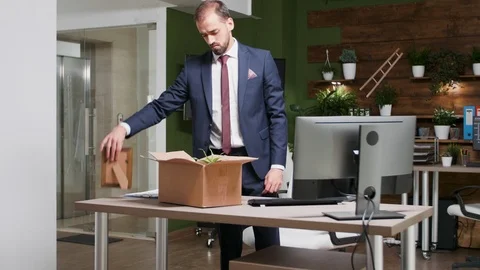 Getting fired - office worker packs his things Stock Footage 109609315