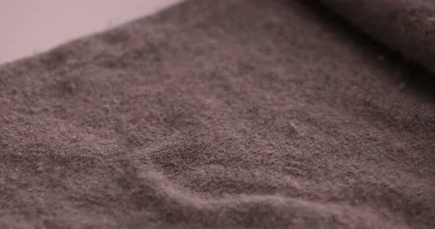 Getting fuzz off of a sweater with a razor blade Stock Footage 132219116