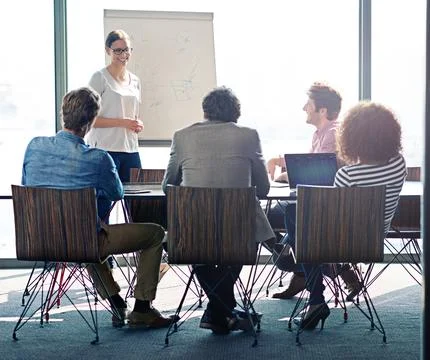 Getting a head start on the project. Shot of a group of coworkers sitting in on Stock Photos