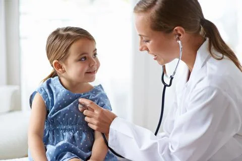 Getting her yearly check-up. an adorable young girl with her pediatrician. Stock Photos