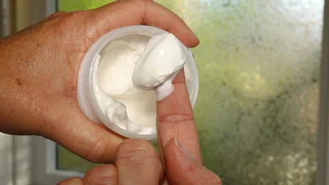 Getting lotion from a jar Stock Footage 119439551