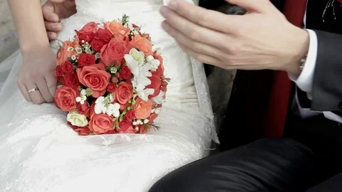 Getting Married. In the hands of the bride bouquet of red roses Stock Footage 72571817