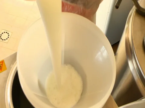 Getting the milk in a great funnel Stockbeeldmateriaal 81015346
