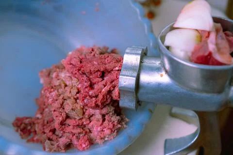 Getting minced meat using a manual meat grinder Stock Photos