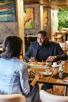 Getting the Most Out of Lunch. Two colleagues having lunch in company's Stock Photos