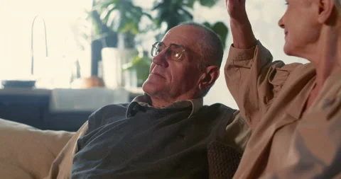 GETTING OLD TOGETHER. Happy serene 70s retired senior woman sits down, hugs her Stock-Footage 164004643