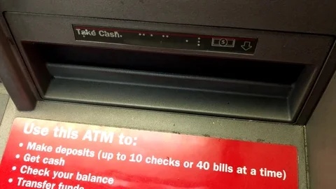 Getting out cash from an ATM machine Stock Footage