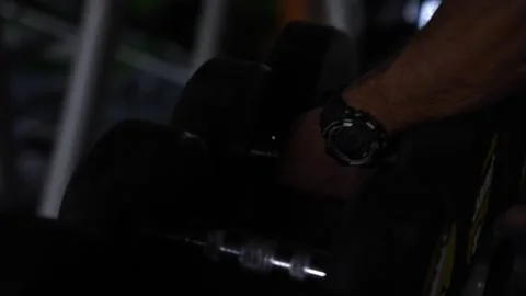 Getting out dumbbells in the gym Видео 247284663