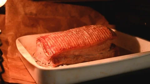Getting pork roast ready and cooking it in an oven Stock Footage 116226200
