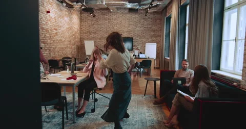 GETTING A RAISE Camera follows young businesswoman enter office with fun dance Video stock 194188044