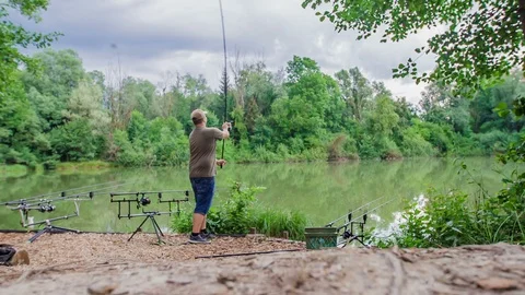 Getting ready and throwing a fishing rod into the water Stock Footage 112175807
