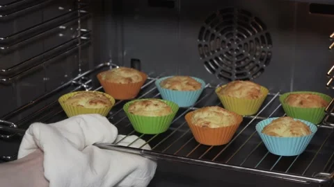 Getting ready cottage cheese muffins out of oven Stock Footage 146593209
