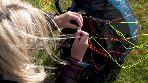 Getting ready to go paragliding, connecting a brummel hook 스톡 동영상 171283805