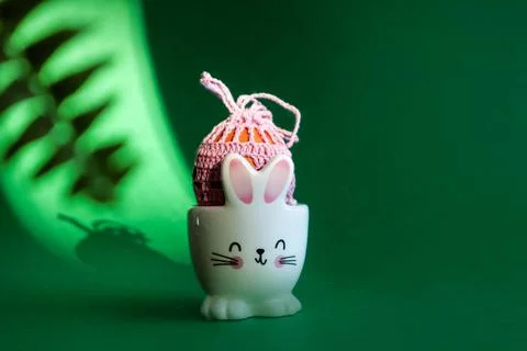 Getting ready for the holiday: an egg decorated with pastel yarn in a stand i Stock Photos