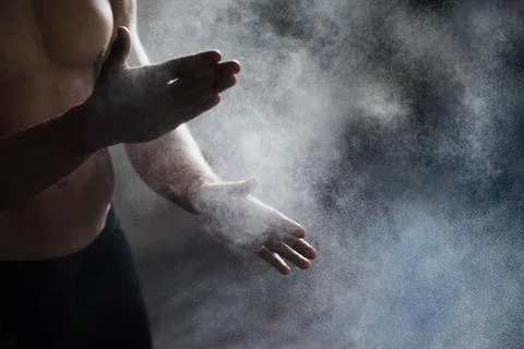Getting ready to perform. A cropped view of a male gymnast dusting his hands Stock Photos