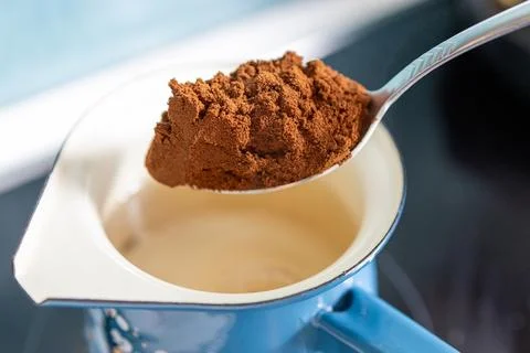 Getting ready to pour ground coffee into the water. Stock Photos