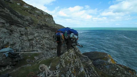 Getting ready for rock climbing by the sea Stock Footage 236710437