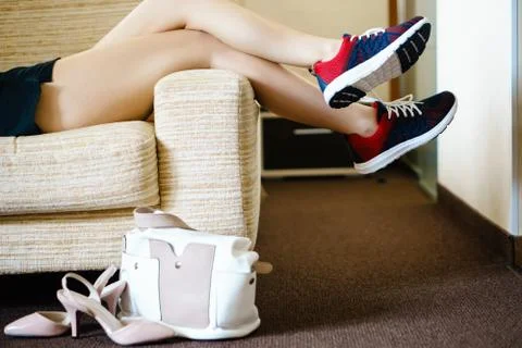 Getting ready for training. The concept of female feet after work. Stock Photos