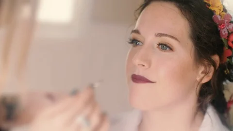 Getting Ready for Wedding: Attractive young Bride to be has makeup applied Stock Footage 119988398
