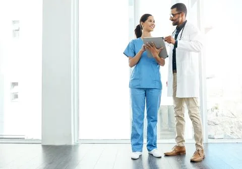 Getting a second opinion doesnt hurt. two young doctors using a digital tablet Stock Photos