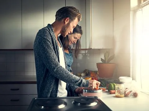 Getting some cooking pointers from mom. Shot of a mother and her adult son co Stock Photos