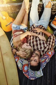 Getting some rest before continuing their journey. a young couple lying at the Stock Photos