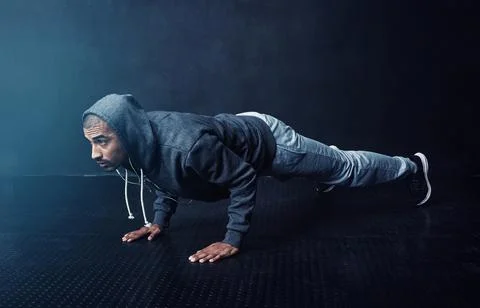 Getting stronger with every rep. Studio shot of a young man doing pushups Stock Photos