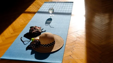 Getting suntan on a yoga mat. Shadow of a girl moving towards the window. Video stock 130154530