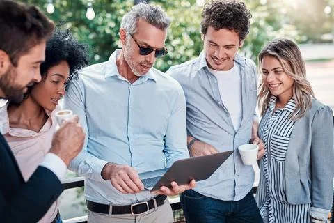 Getting the team on the same page. Shot of a group of businesspeople working  Stock Photos