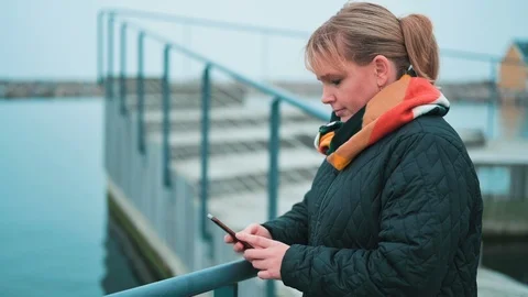 Getting text messages while standing outside in the cold Stock Footage 122258059