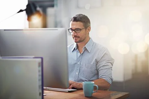 Getting things done, one click at a time. Cropped shot of a businessman working Stock Photos